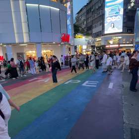 A verified photo of a rainbow crossing at dusk pinned to the map